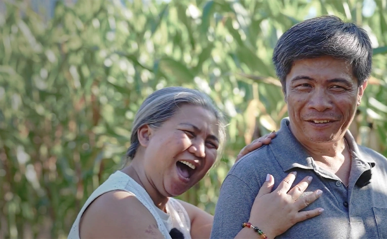 A man and a woman smiling.