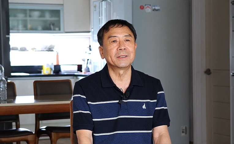 A man sitting in a kitchen.