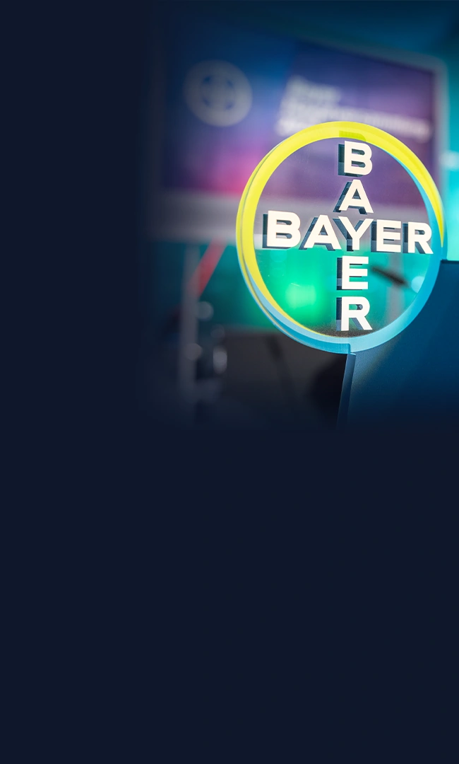 Bayer logo on a colorful background.
