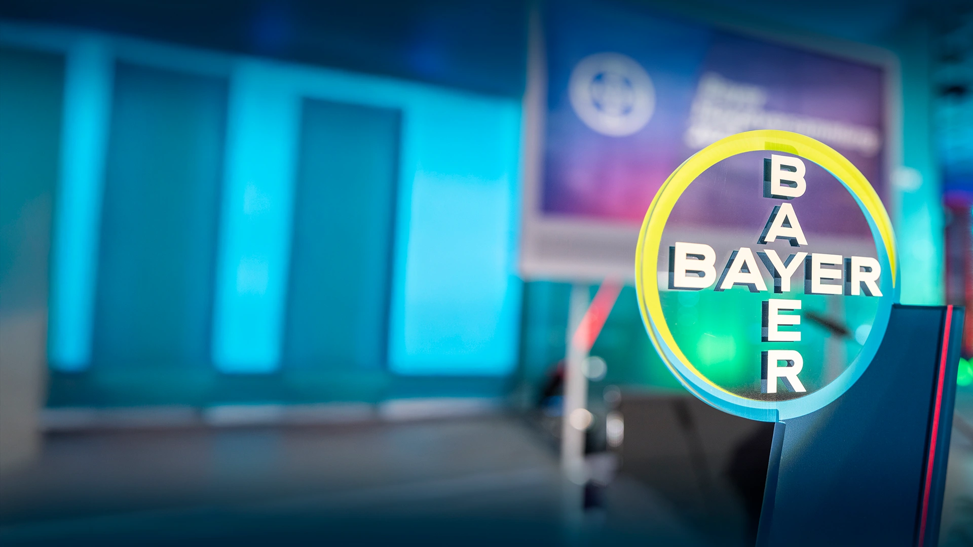 Bayer logo on a colorful background.